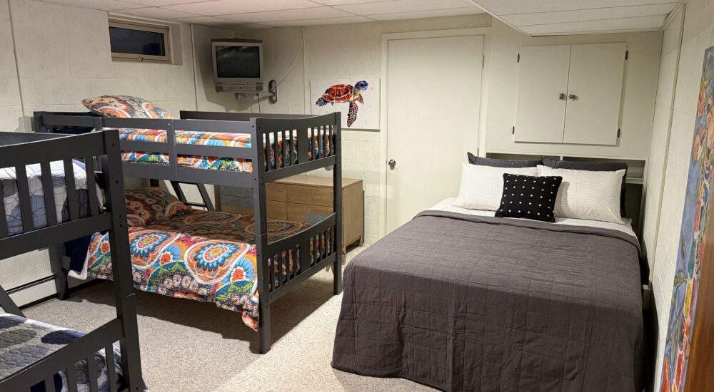 One of the downstairs bedrooms - two bunk beds with an additional full-sized bed